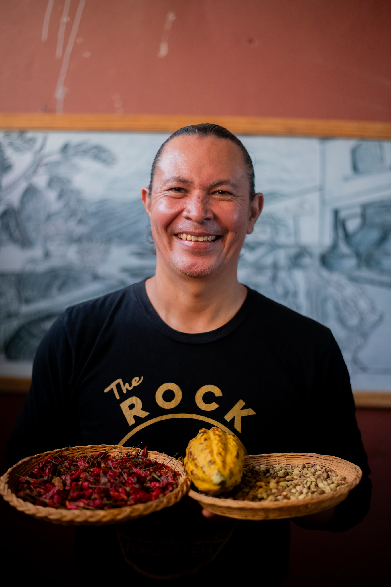 Efraín López holding Honduran cacao at the source